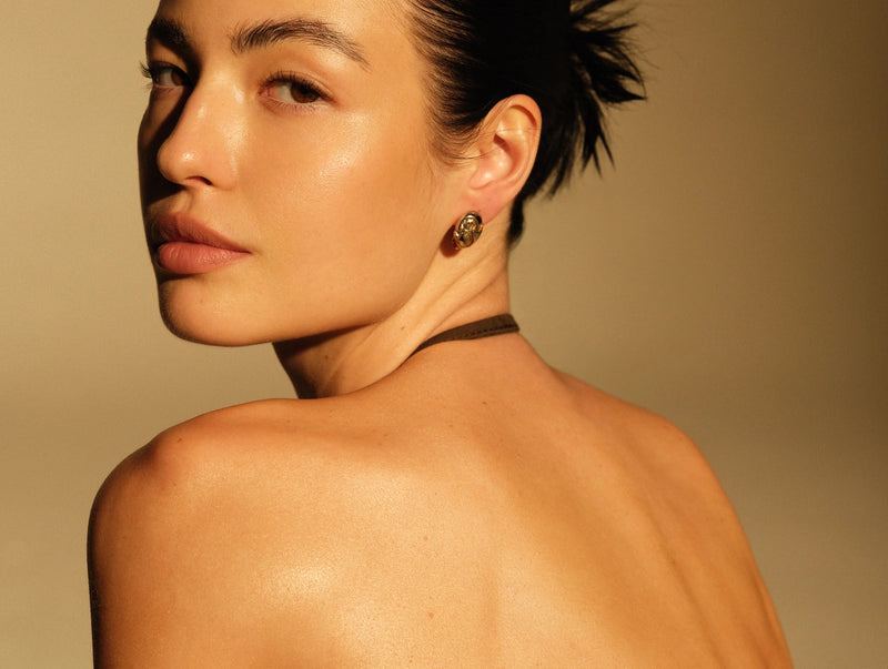 Woman looking back over her shoulder in warm natural light